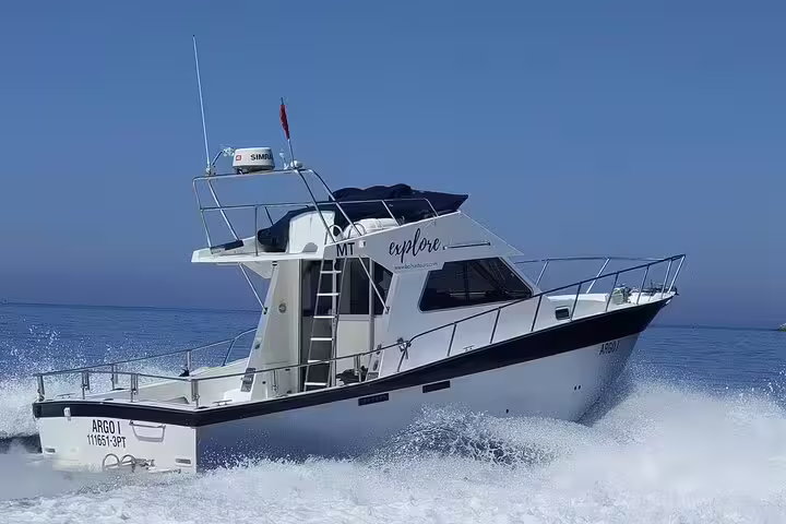 Luxury sport fishing boat cruising through clear blue waters on an all-inclusive tour in Sesimbra, perfect for adventure seekers.