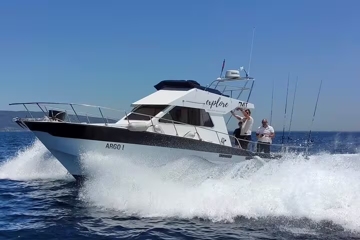 Modern sport fishing boat cruising through clear waters in Sesimbra, Portugal, perfect for an all-inclusive fishing adventure.