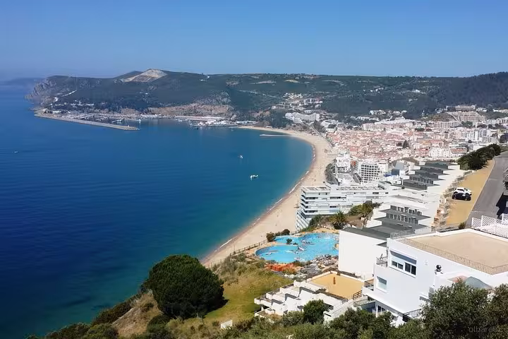 Stunning aerial view of Setúbal coastline with sandy beaches and azure waters ideal for private tours.