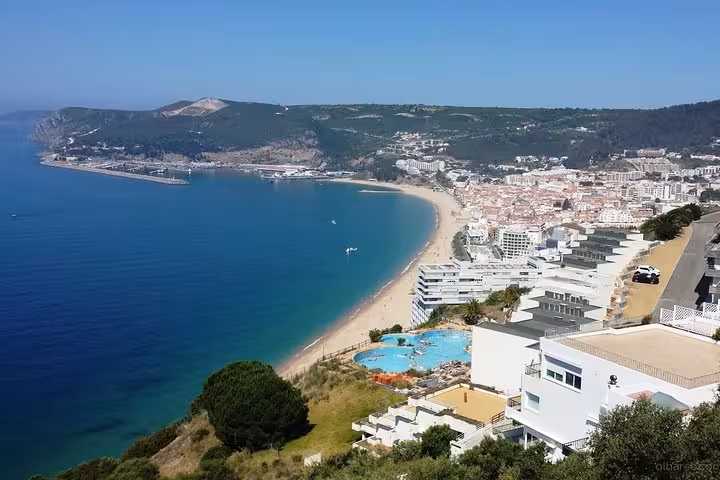 Scenic view of Setúbal coastline with sandy beaches and hills, perfect for private tours to Arrábida and Sesimbra.