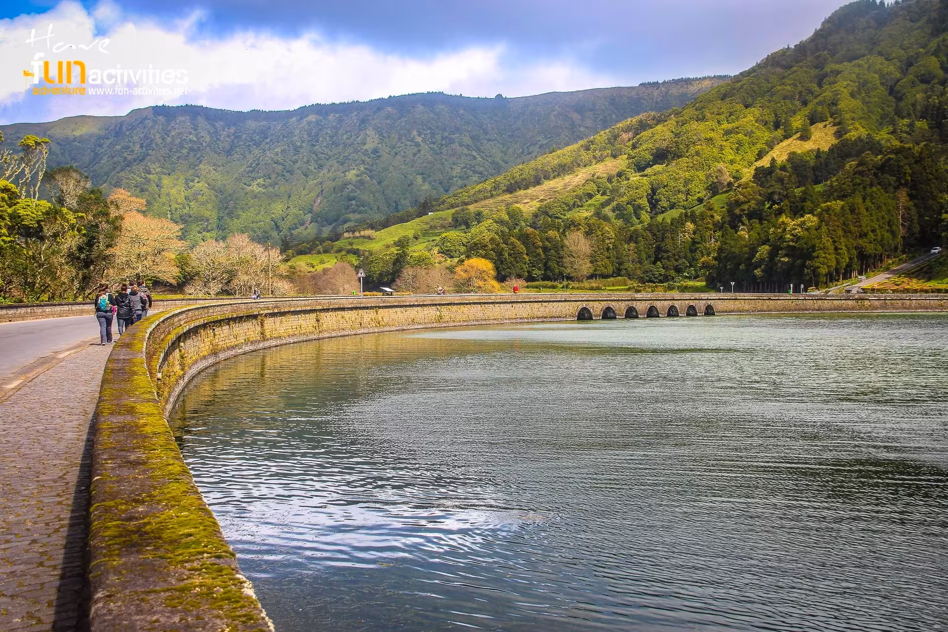 Walking along Sete Cidades lagoon wall with mountain scenery on the HIKE Seven Cities - Ferraria tour, Azores