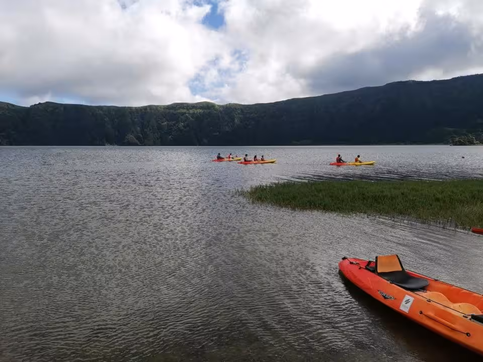 Colorful kayaks glide across Sete Cidades crater lake in the Azores on a guided full-day jeep and kayak adventure tour