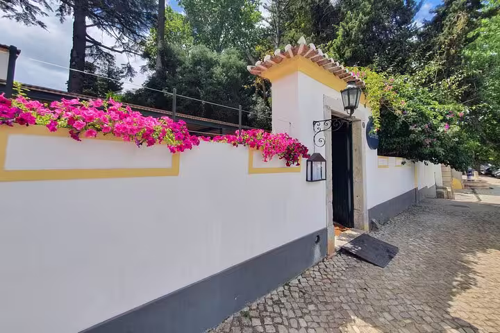 Picturesque entrance adorned with vibrant flowers in Setúbal, offering a warm welcome to visitors exploring local culture.