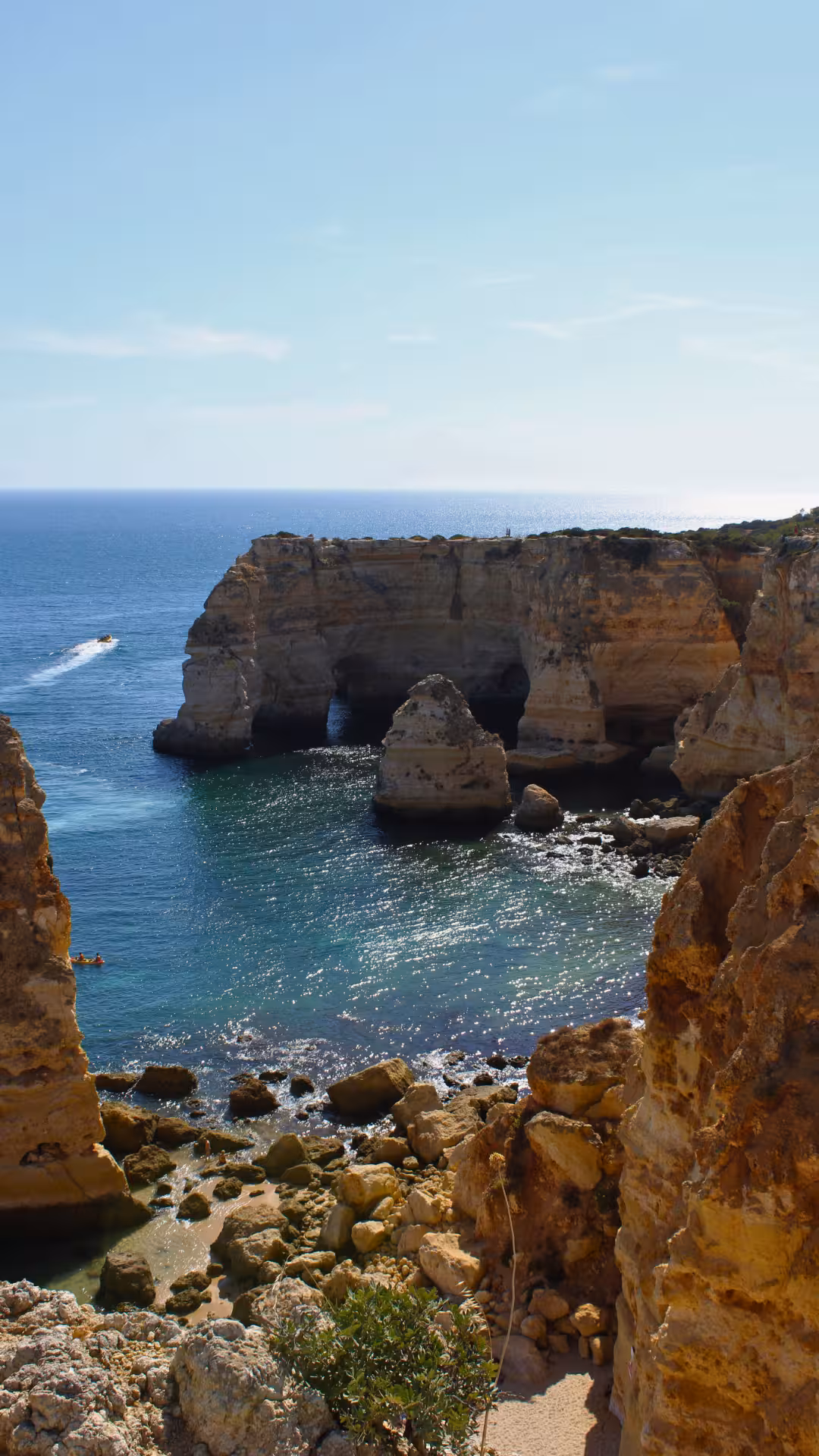 Dramatic limestone cliffs and sea arches of Algarve’s Seven Hanging Valleys, viewed from a scenic coastal hiking and biking trail