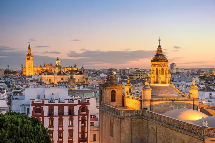 Sunset view of Seville skyline highlighting the Alcazar and Cathedral, ideal for Cadiz port cruisers on a skip-the-line tour.