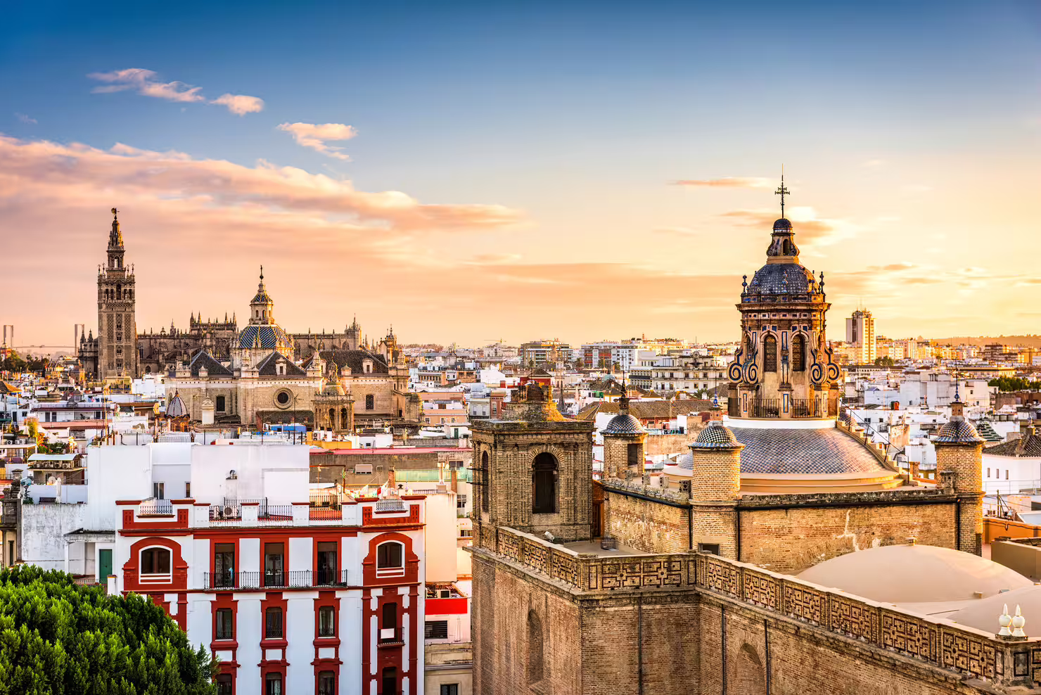 Seville skyline at sunset with Giralda and historic rooftops, perfect for Alcazar and Plaza de España 1-day walk