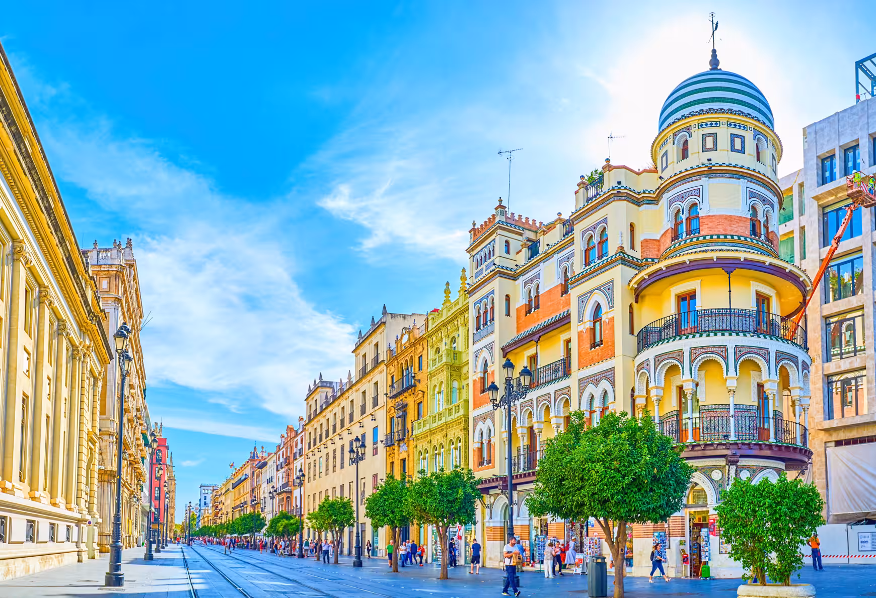 Seville city center street with colorful Andalusian architecture and orange trees, Encantos Locales + Tablao Flamenco tour