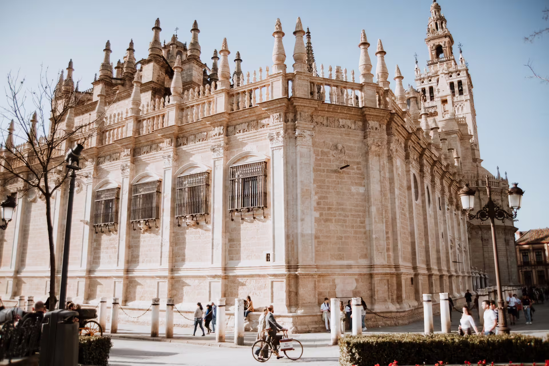 People explore the historic Seville Cathedral on a sunny day during a small group walking tour in Seville, Spain.