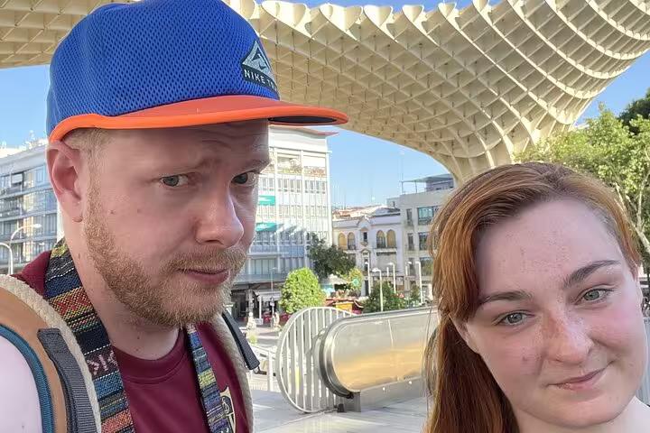 Two tourists taking a selfie at Seville's Metropol Parasol during a self-guided city tour