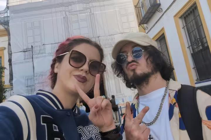 Two tourists making peace signs on a self-guided city tour in Seville, Spain