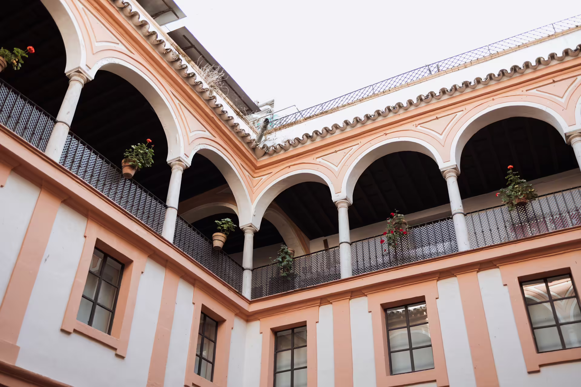 Elegant arched balconies of Seville's Fine Arts Museum, showcasing Spanish architecture on a guided cultural tour.