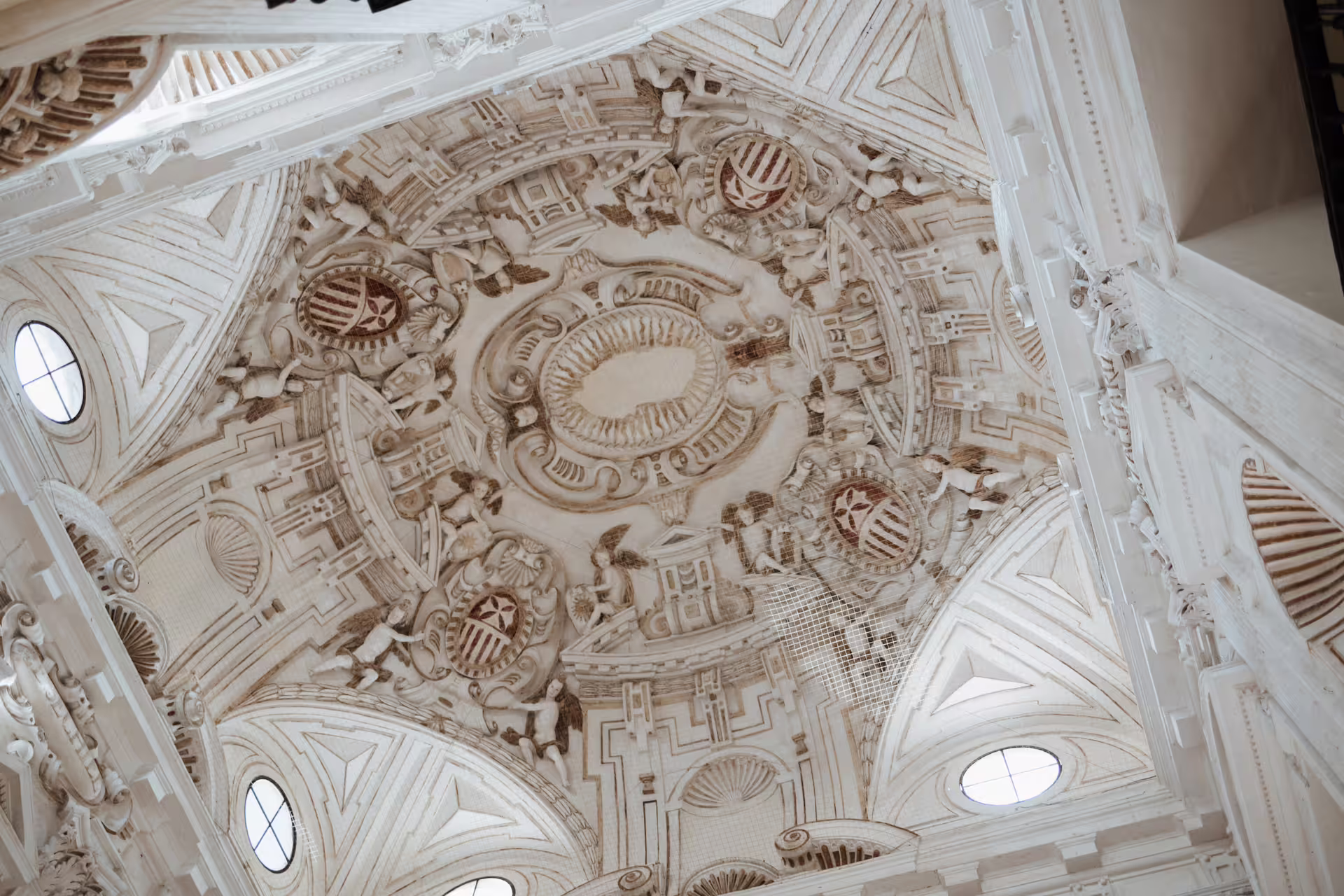 Ornate ceiling detail at Seville's Fine Arts Museum, showcasing intricate Baroque architecture on a guided tour.
