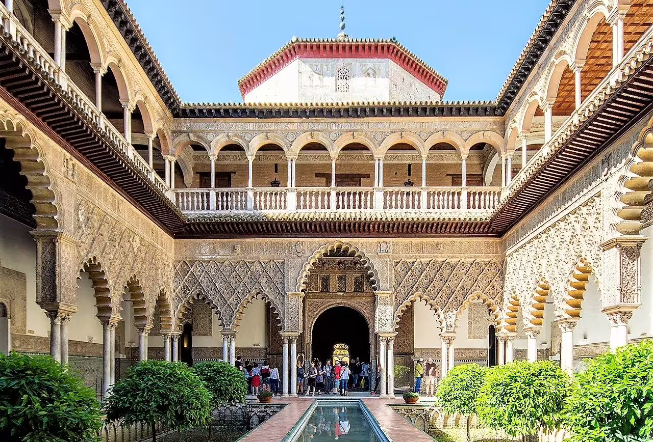 Guided Seville group walking tour at the Alcazar courtyard, Moorish arches, reflecting pool and gardens