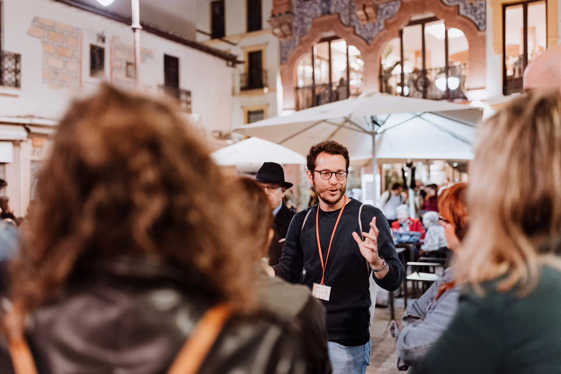 Tour guide engaging a group during the Seville Mysterious and Paranormal Tour, exploring historic and haunted sites at night.