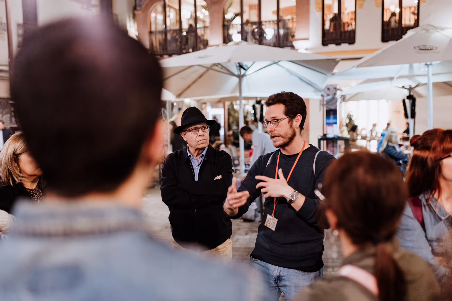 Tour guide engaging a group in Seville's historic square during a mysterious and paranormal city tour at night.