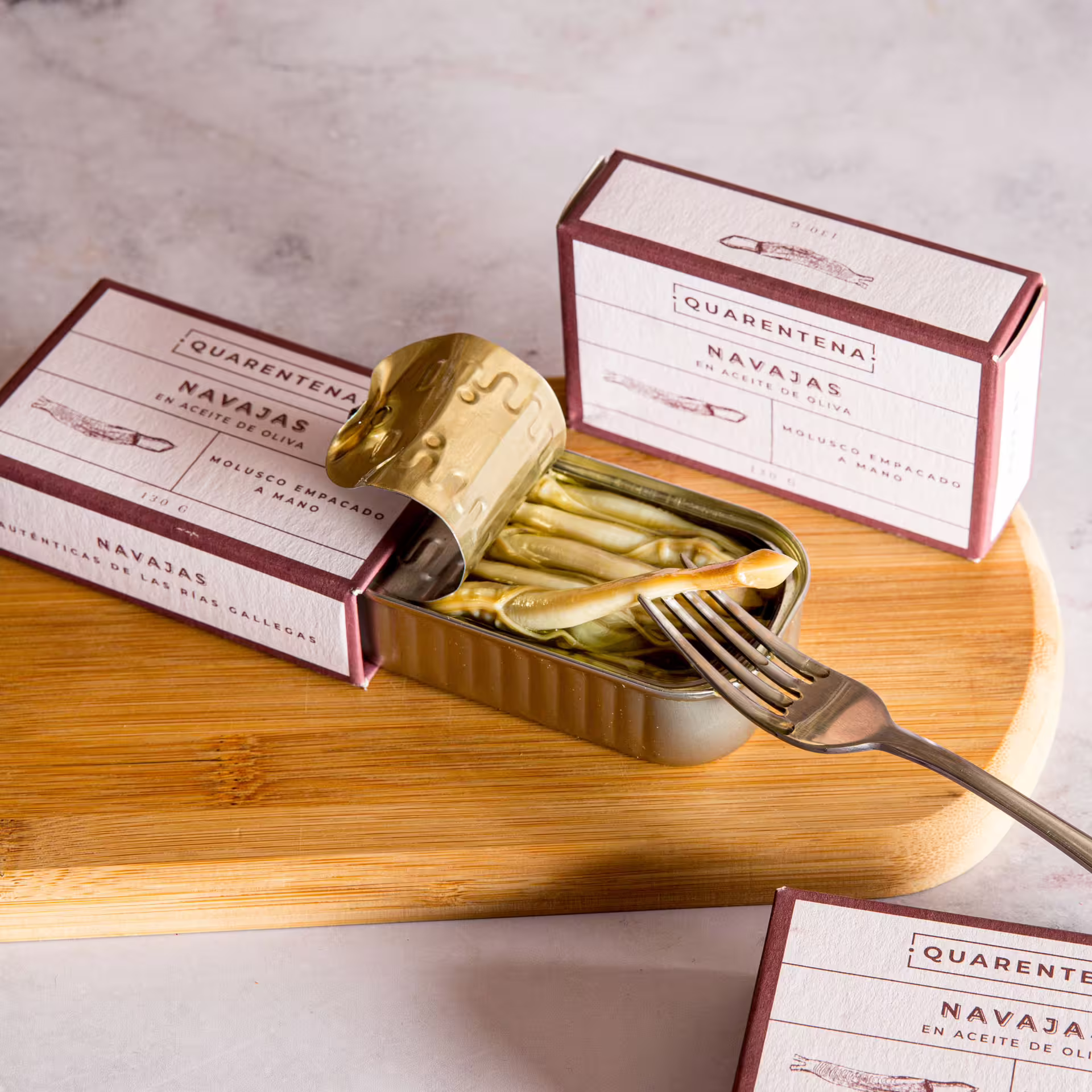 Gourmet razor clams in olive oil served during a private food tour of Seville, showcasing authentic Spanish seafood delicacies.