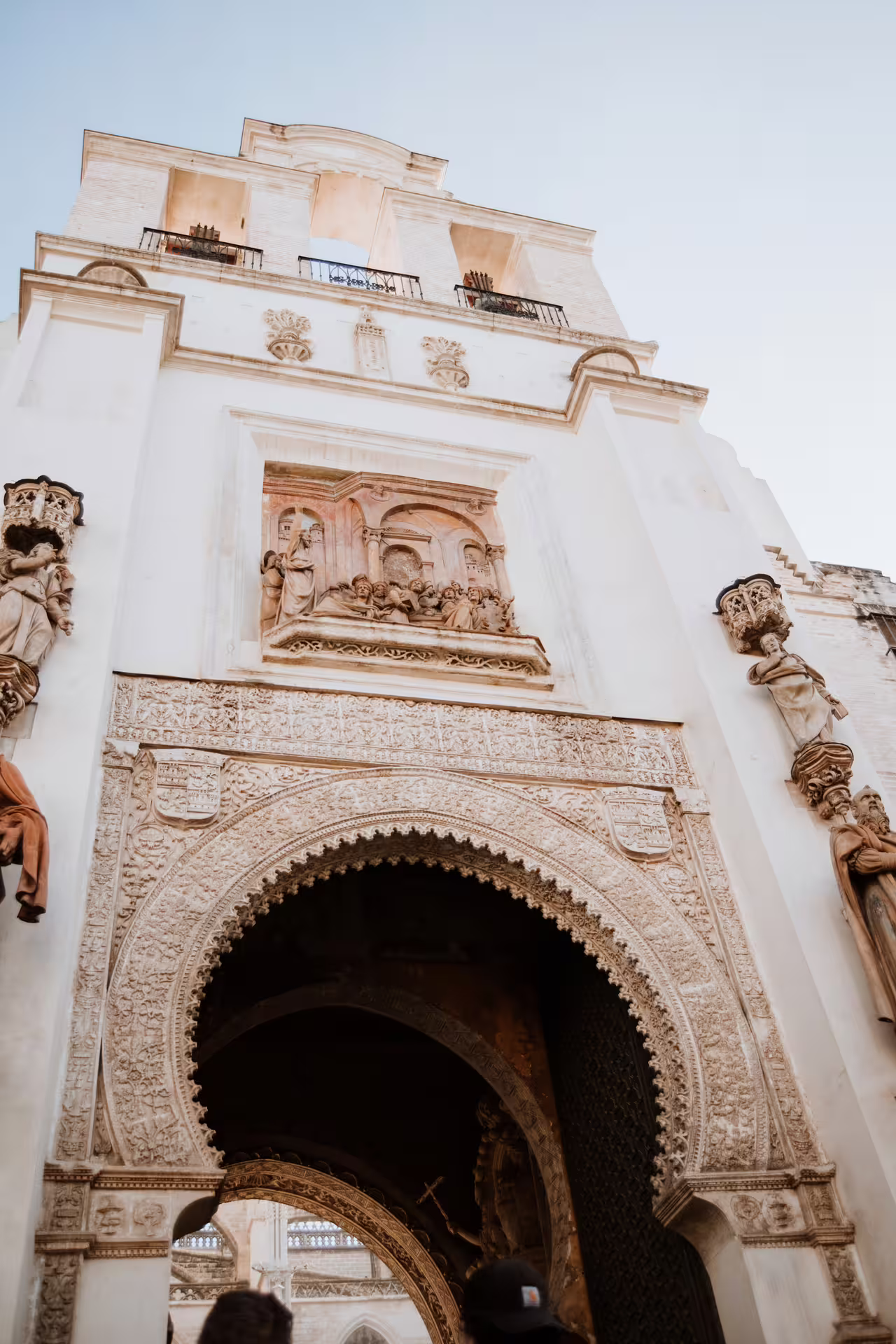 Ornate archway and sculptures at historic Seville site, featured on Brotherhood's Seville Private Tour, showcasing Andalusian art.