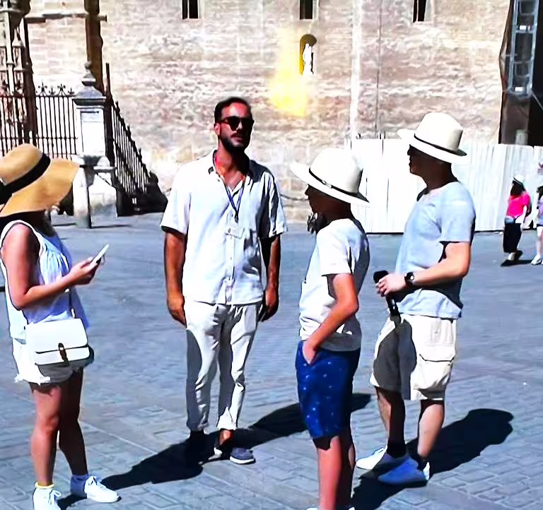 Private guide briefing travelers during a Seville private walking tour near the Alcázar walls in sunshine