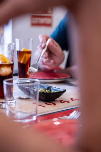 Close-up of tapas and refreshing drinks at a traditional Seville restaurant on a historic walking tour.