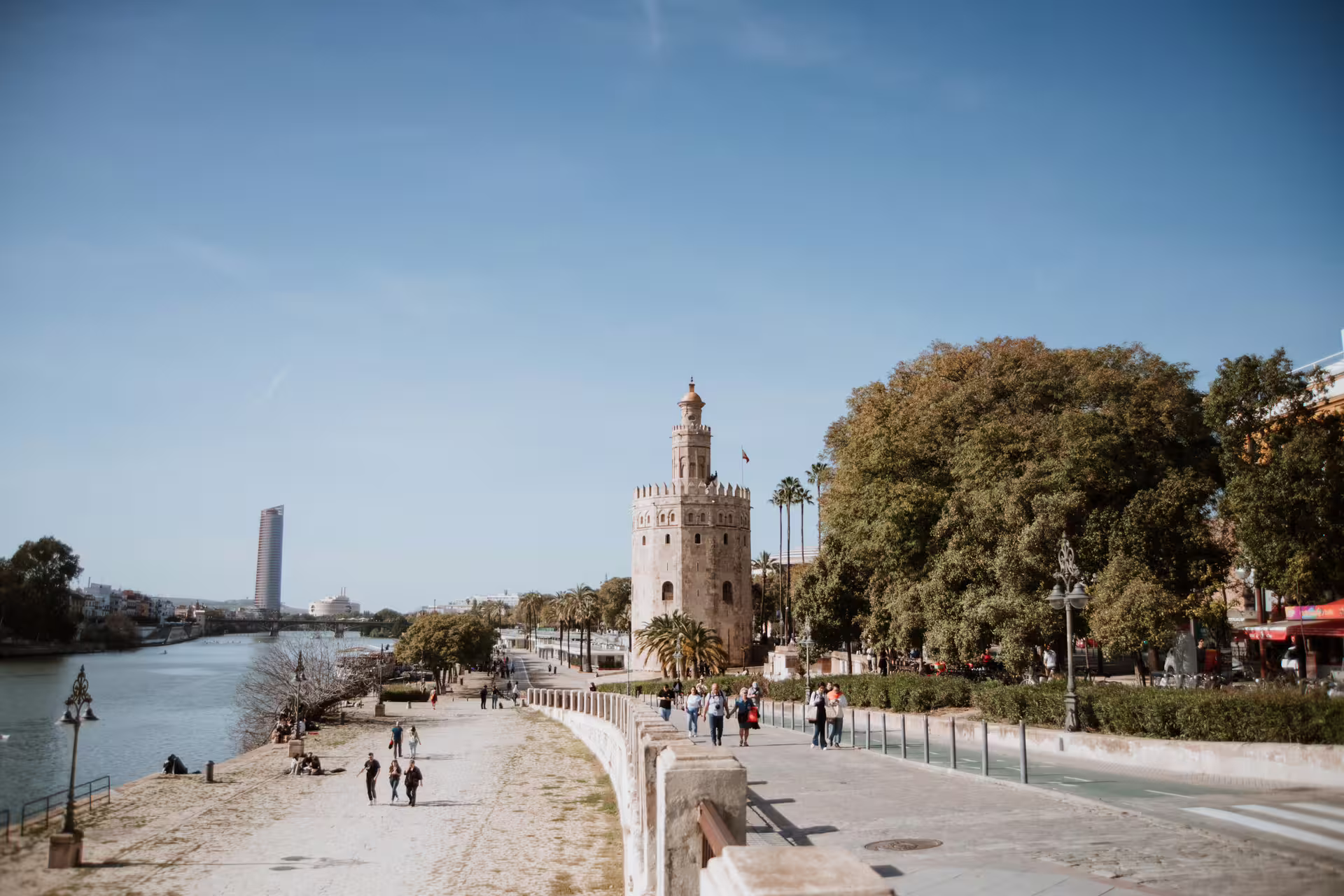 Small group walking tour in Seville showcasing Torre del Oro and scenic riverside views, perfect for cultural exploration.
