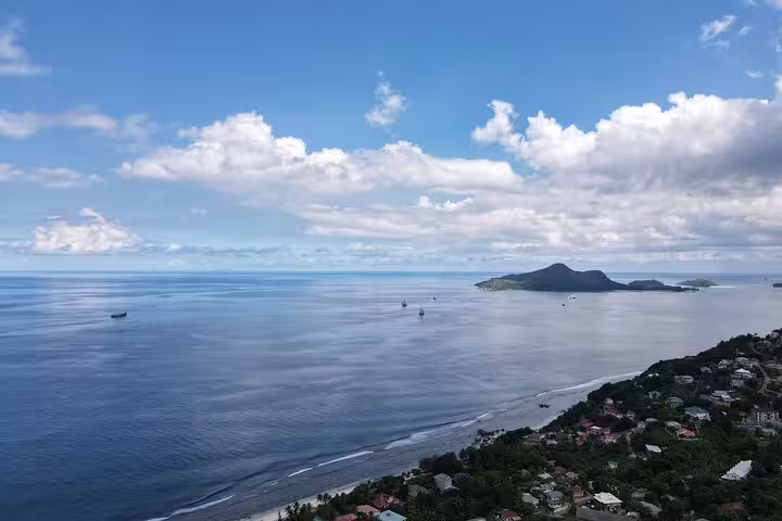 A breathtaking aerial view of Seychelles coastline with lush greenery and tranquil ocean, perfect for a private island tour.