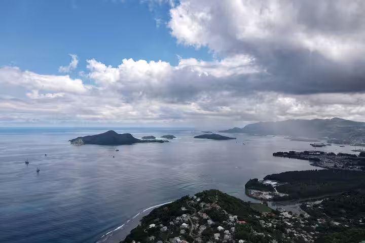 Stunning panoramic view of Seychelles islands under a partly cloudy sky, perfect for an exclusive island tour adventure.