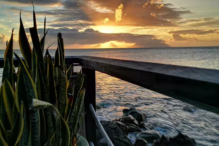 Breathtaking Seychelles sunset view from a coastal deck, perfect for a serene island tour.
