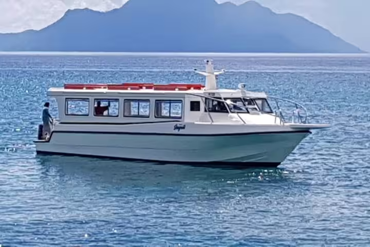 Elegant boat cruising the turquoise waters of Seychelles, ideal for exclusive VIP transport and island hopping adventures.