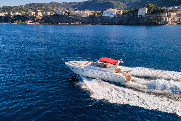 Luxurious Shamal 40 yacht cruising along the stunning Sorrento coastline, offering exclusive tours to Capri and Positano.