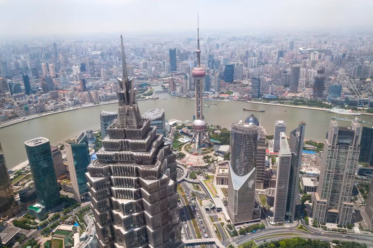Aerial view of Shanghai skyline featuring iconic skyscrapers and the Huangpu River on the Classic China tour.