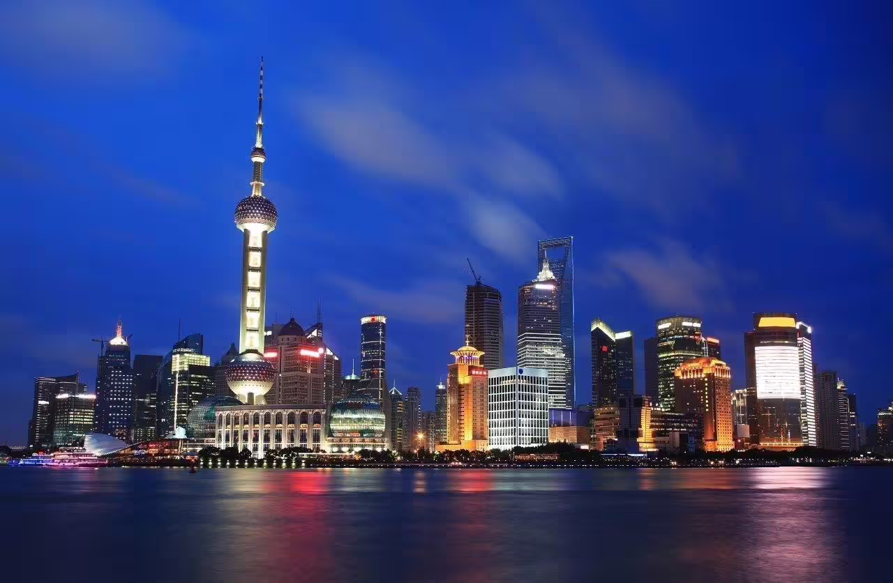 Shanghai skyline illuminated at night featuring iconic skyscrapers on a private cosmopolitan city tour.
