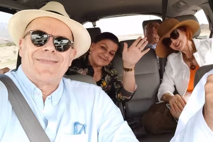 Happy senior travelers enjoy a comfortable private transfer from Shangri-La resort to Muscat International Airport in Oman