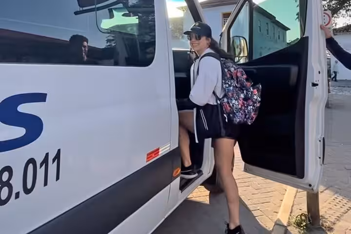 Traveler boarding a shared shuttle in Rio de Janeiro for a scenic trip to Angra dos Reis.