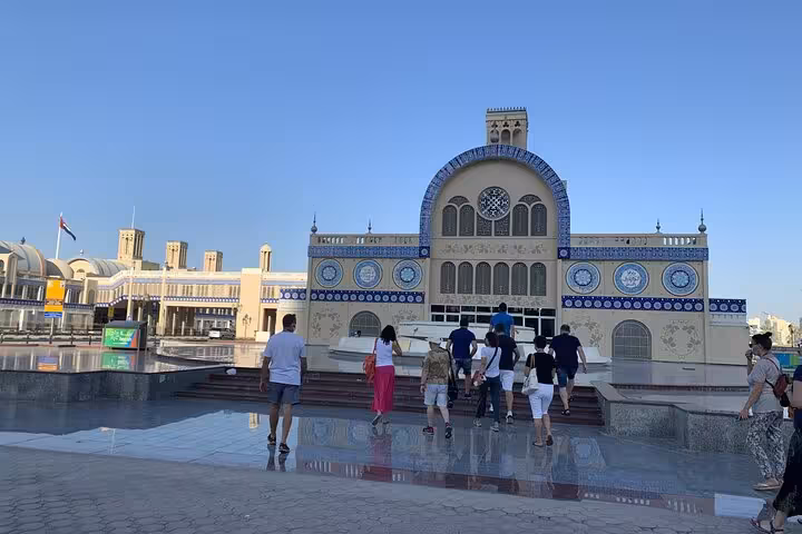 Visitors walking toward Sharjah Blue Souk, iconic UAE heritage attraction on Emirates history and culture tour