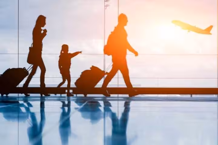 Travelers with luggage at airport window, ideal for Sharm El Sheikh airport private pickup and drop-off