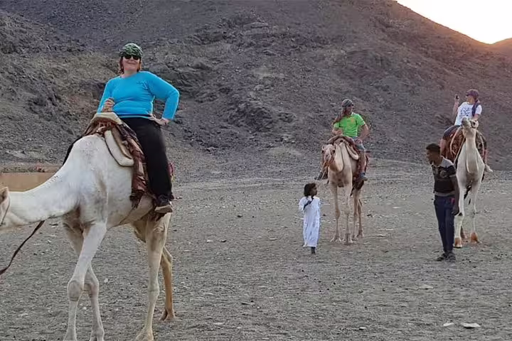 Tourists on camel ride in Sinai desert on Sharm El Sheikh Bedouin safari and stargazing adventure