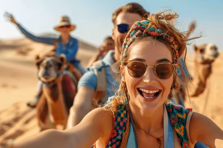 Smiling traveler on camel trek across Sharm El Sheikh desert dunes, combo safari and water sports tour