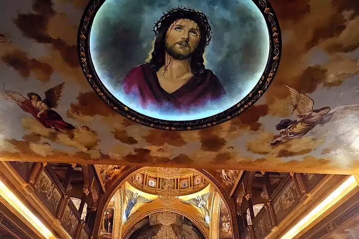 Interior ceiling fresco and ornate arches at a Sharm El Sheikh church, guided city sightseeing tour stop