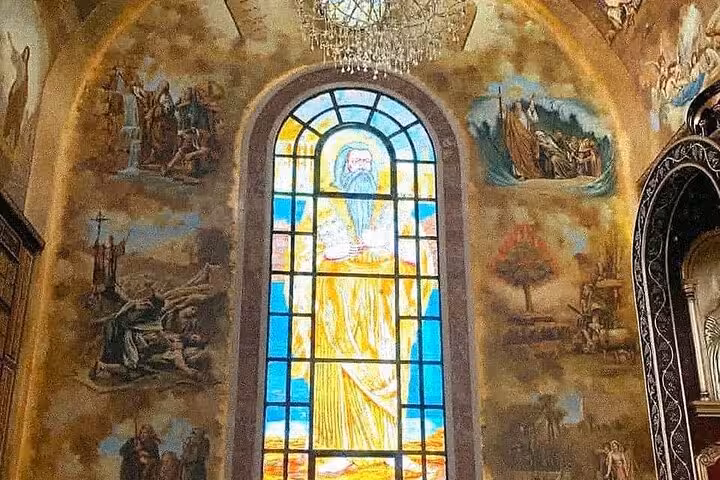 Stained-glass window and biblical murals inside Sharm El Sheikh church on Farsha Cafe city tour