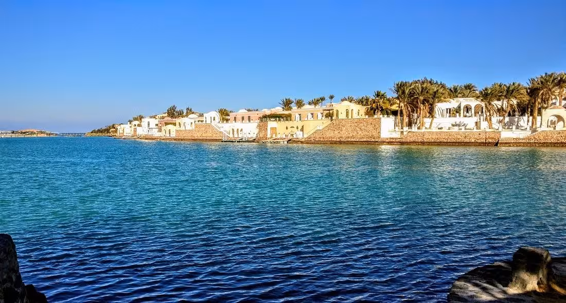 Scenic view of Sharm el Sheikh's coastal villas and pristine blue waters under a clear sky.