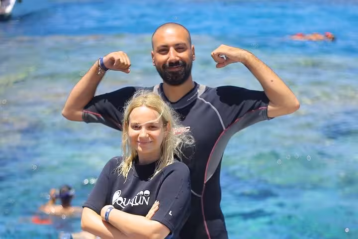 Guests in wetsuits posing by Red Sea on Sharm El Sheikh day sail to Ras Mohamed and White Island snorkeling