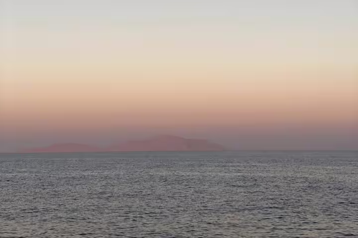 Calm Red Sea sunset horizon from Sharm El Sheikh, scenic backdrop for an evening dinner cruise by boat