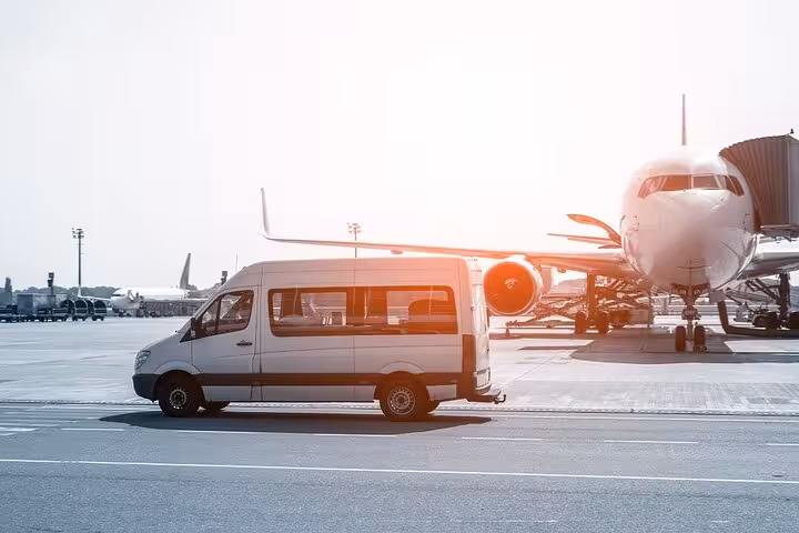 Airport transfer van beside plane for Sharm El Sheikh to Luxor day trip by flight with pickup service
