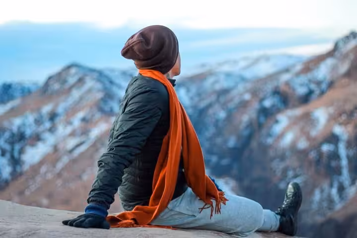 Traveler resting on Mount Sinai summit viewpoint on Sharm El Sheikh sunrise hike and monastery tour