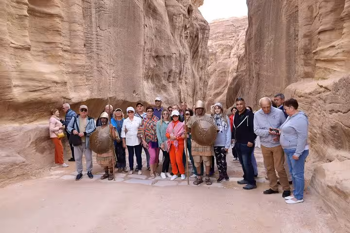 Tour group in Petra Siq canyon on Sharm El Sheikh to Petra day tour by ferry, guided Jordan excursion