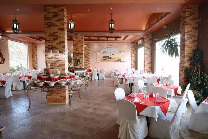 Restaurant buffet lunch stop on Sharm El Sheikh to Petra day tour by ferry, tables set in dining hall