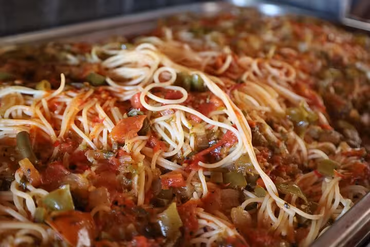 Hot buffet pasta with tomato sauce served on Sharm El Sheikh to Petra ferry day tour lunch stop