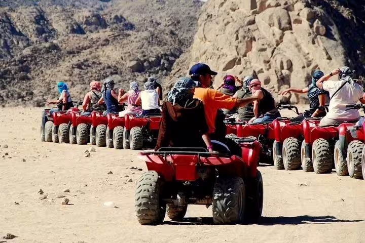 ATV convoy on Sharm El Sheikh quad biking safari through Sinai mountains, part of camel ride and Bedouin dinner tour