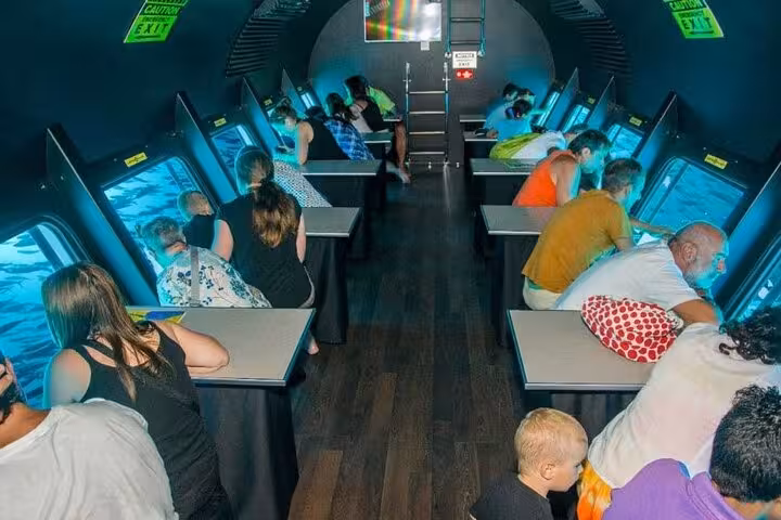 Passengers viewing Red Sea coral through panoramic windows on Sharm El-Sheikh semi submarine tour