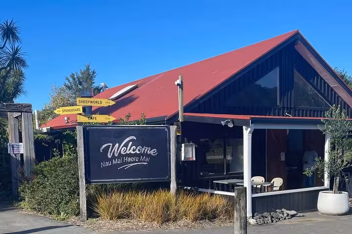Welcoming entrance to Sheep World with directional signs, offering a charming start to the Auckland countryside experience.